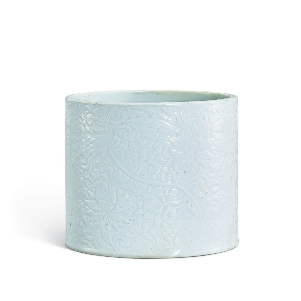 View full screen - View 1 of Lot 380. A carved white-glazed 'lotus' brushpot, Qing dynasty, Kangxi period 清康熙 白釉刻纏枝蓮紋筆筒 《成化年製》仿款.