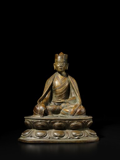 View full screen - View 1 of Lot 126. A large copper and silver-inlaid copper alloy figure of the First Karmapa Lama, Tibet, 14th / 15th century.