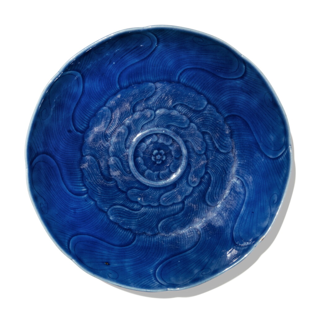 View full screen - View 1 of Lot 115. A carved blue-glazed dish, Qing dynasty, 18th century .