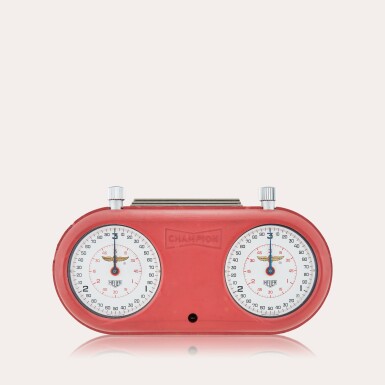 View full screen - View 1 of Lot 125. Reference 503.202 Indianapolis Motor Speedway | Two stainless steel stopwatches with fitted rubber Champion Spark Plugs case, 1970.