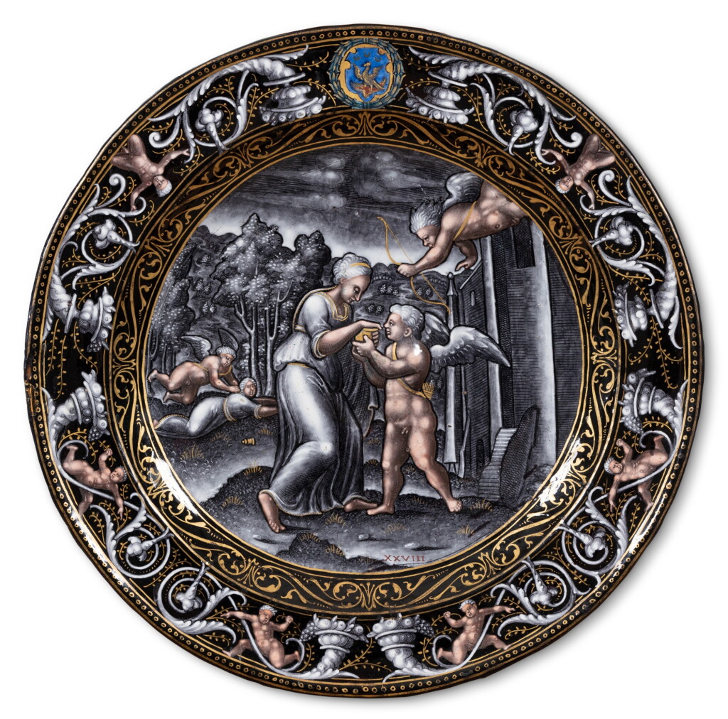 View full screen - View 1 of Lot 118. A Limoges grisaille painted enamel circular plate with Cupid and Psyche, Attributed to Pierre Reymond (1513-1584), circa 1570-1575.