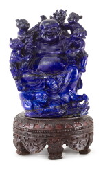 A LAPIS LAZULI FIGURE OF BUDAI, LATE QING DYNASTY - REPUBLICAN PERIOD | 晚清至民國 青金石雕童子戲彌勒像