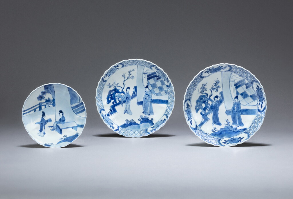 View full screen - View 1 of Lot 182. Two blue and white barbed-rim 'Romance of the Western Chamber' dishes and a saucer, Qing dynasty, Kangxi period | 清康熙 青花西廂記故事圖菱口盤及小盃 一組三件.