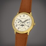 A yellow gold wristwatch with day, date and moon phases | Circa 1990