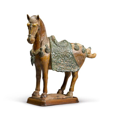 View full screen - View 1 of Lot 287. An amber and green-glazed pottery model of a caparisoned horse Tang dynasty style.