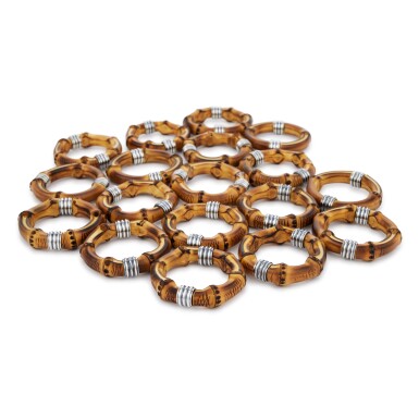 View full screen - View 1 of Lot 312. A Set of Eighteen Italian Silver and Bamboo Tahiti Pattern Napkin Rings, Buccellati, Milan, Modern.
