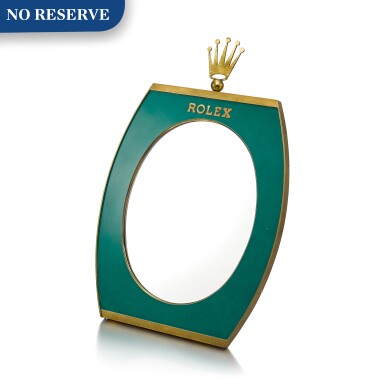 View full screen - View 1 of Lot 8017. ROLEX | A GILT BRASS AND GREEN ENAMEL RETAILER'S DISPLAY MIRROR WITH WOODEN BACK, CIRCA 1960.