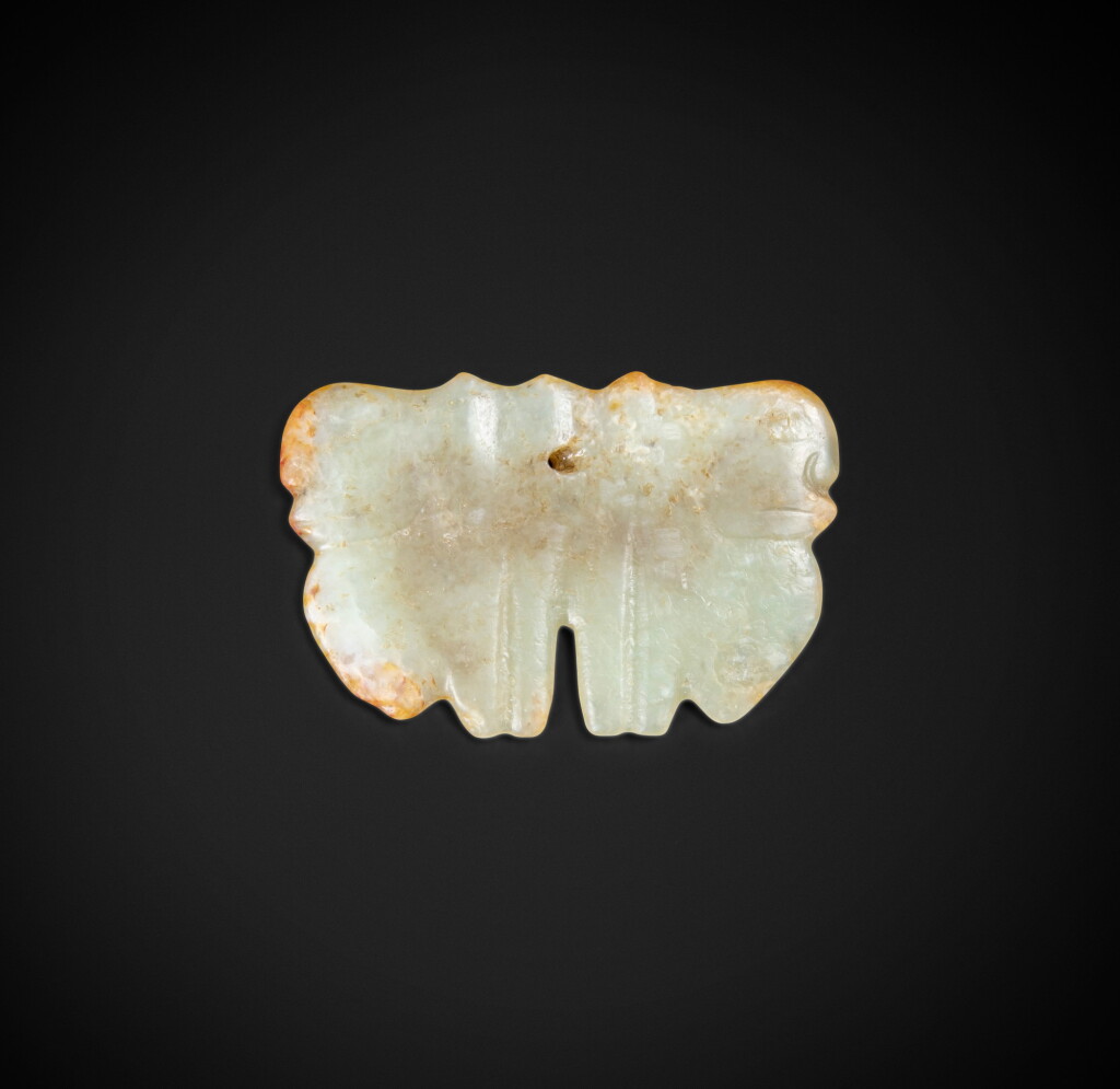 View full screen - View 1 of Lot 87. A rare celadon and russet jade ‘two faces’ pendant Neolithic period, Hongshan culture | 新石器時代 紅山文化青白玉雙面雲形珮.