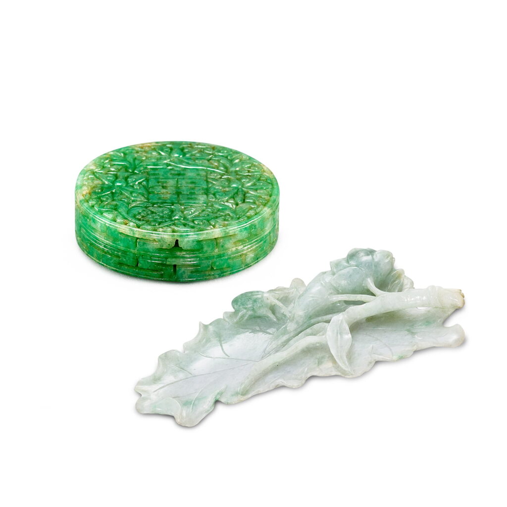View full screen - View 1 of Lot 425. A jadeite carving of a lotus leaf and a reticulated jadeite 'double happiness' box and cover, Qing dynasty 清 翠玉一甲連科 及 翠玉鏤雕囍字圓蓋盒.