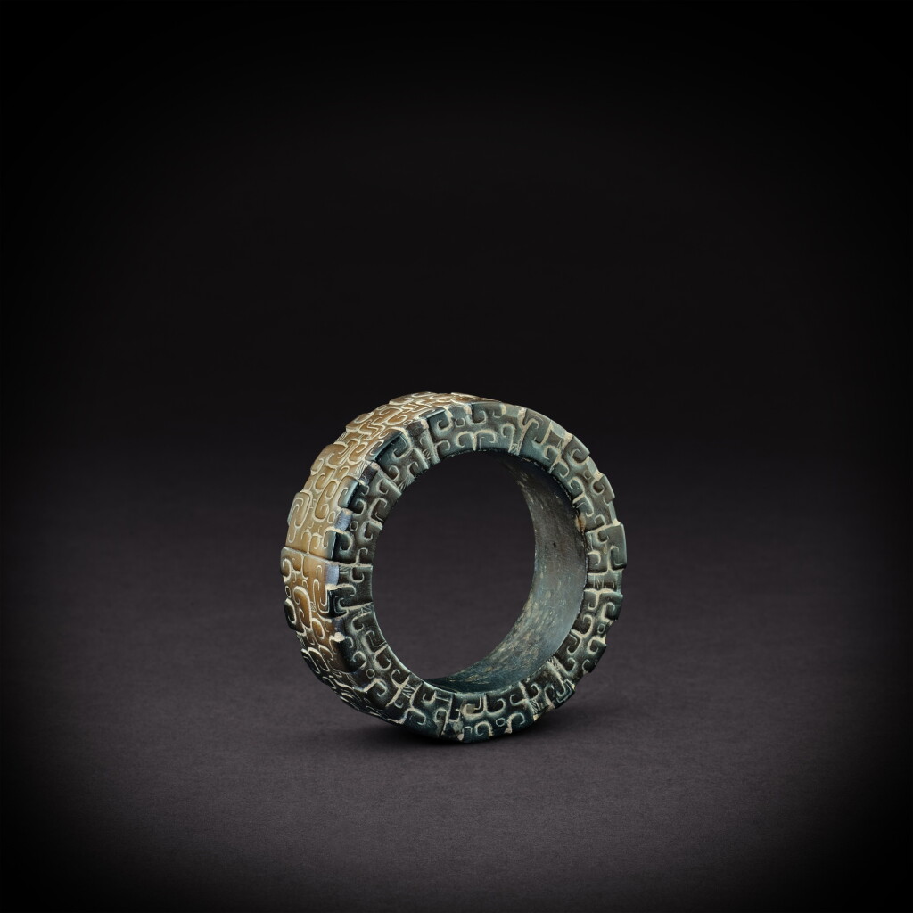 View full screen - View 1 of Lot 3502. A russet jade 'panhui' bangle, Eastern Zhou dynasty, Spring and Autumn period | 東周春秋 褐玉蟠虺紋環.