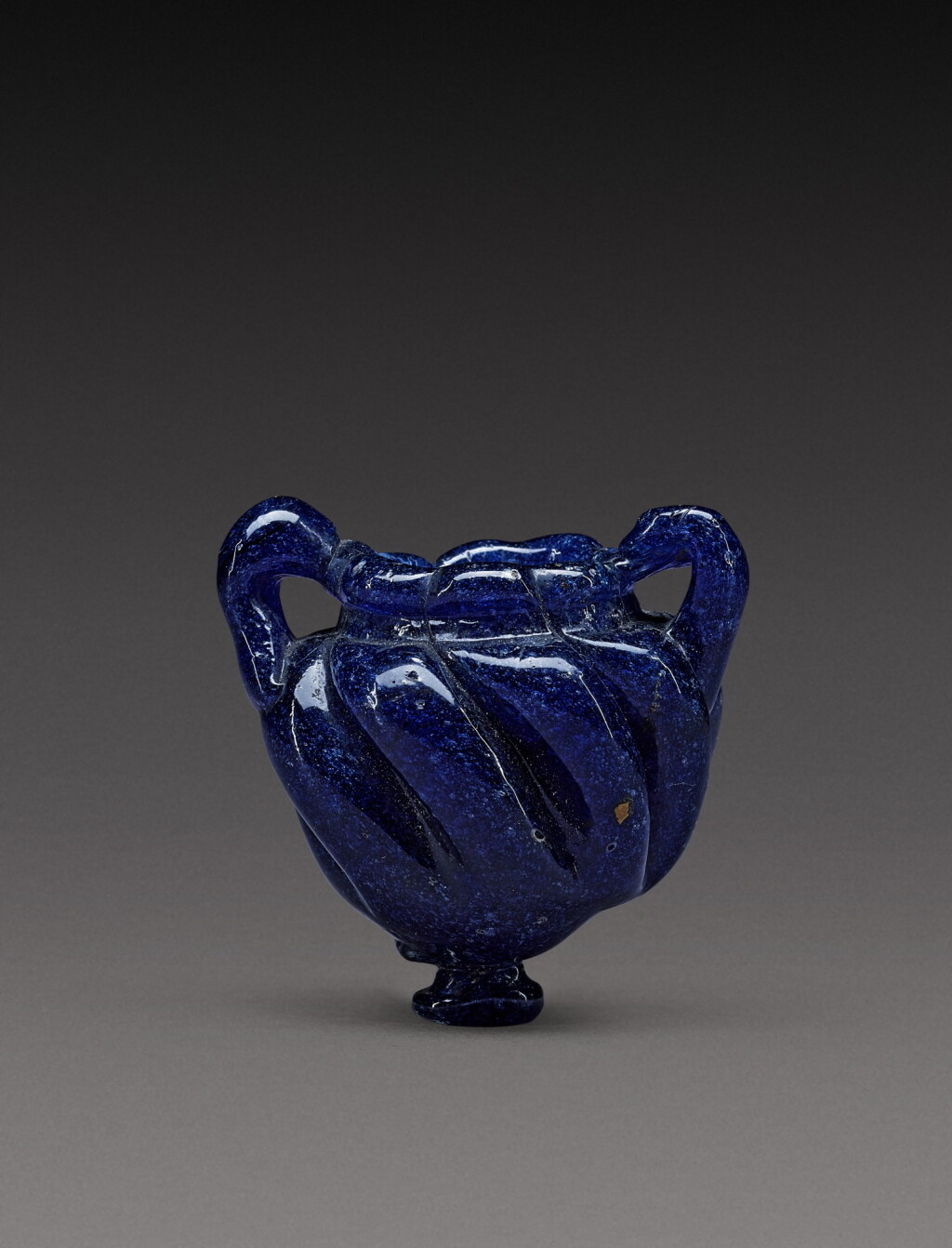 View full screen - View 1 of Lot 9. A Late Roman Cobalt Blue Core-Formed Glass Cosmetic Jar, circa 5th/7th century A.D..