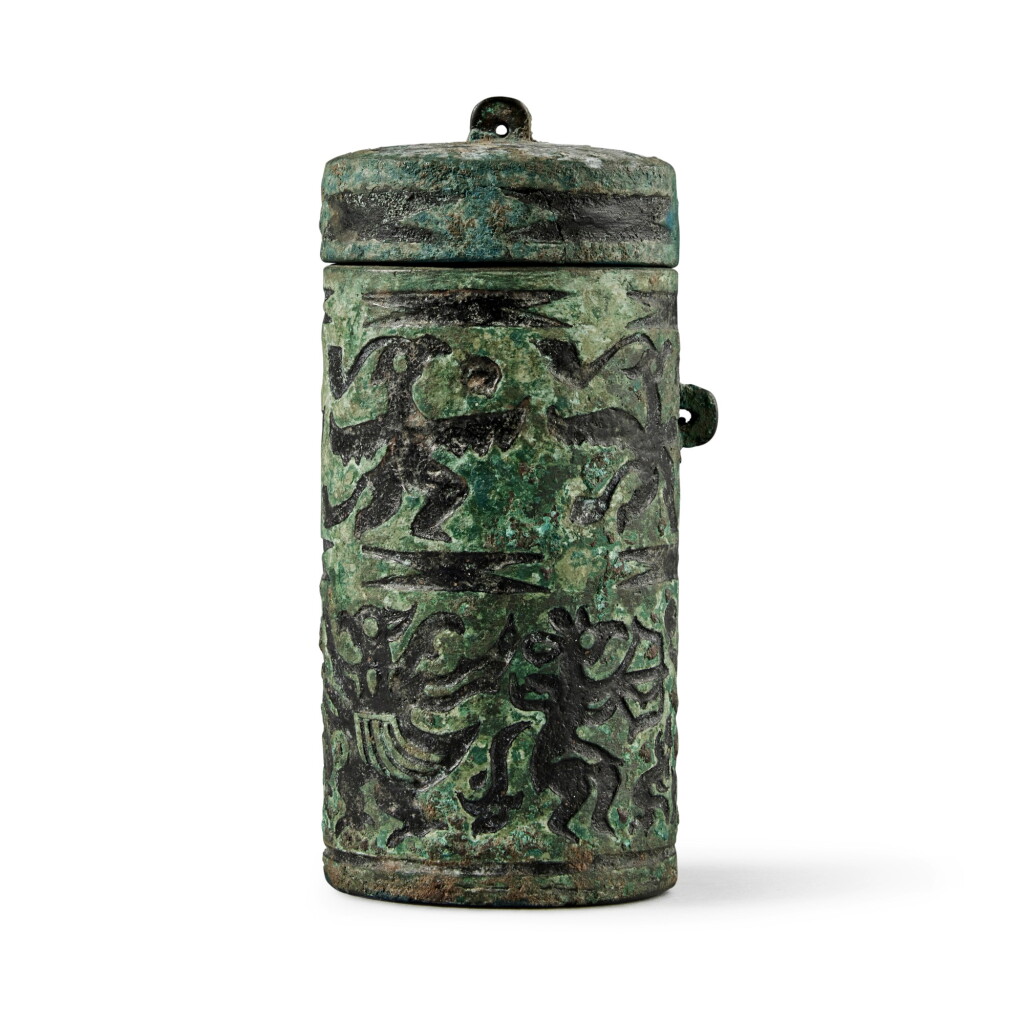 View full screen - View 1 of Lot 44. A rare bronze cylindrical box and cover, Warring States period | 戰國 青銅鳥獸紋蓋筒.