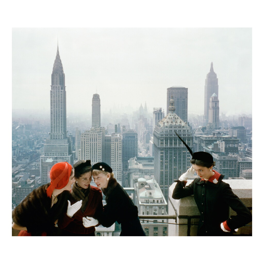 View full screen - View 1 of Lot 211. NORMAN PARKINSON | YOUNG VELVETS, YOUNG PRICES, HAT FASHIONS III (THE NEW YORK SKYLINE FROM THE ROOF OF THE CONDÉ NAST BUILDING ON LEXINGTON AVENUE).