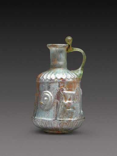 View full screen - View 1 of Lot 4. A Roman Pale Green Mould-Blown Glass Flask, circa 1st century A.D..