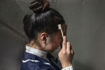 Teen brushing baby hairs during a dance competition