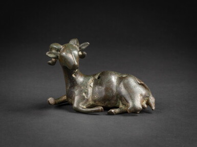 View full screen - View 1 of Lot 66. A bronze figure of a ram Ming dynasty or earlier | 明或更早期 銅鑄臥羊擺件.