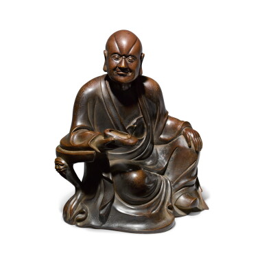 View full screen - View 1 of Lot 83. A silver-inlaid bronze figure of a luohan, Late Qing Dynasty | 晚清 銅錯銀羅漢坐像.