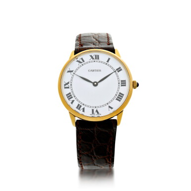 View full screen - View 1 of Lot 68. RETAILED BY CARTIER: A YELLOW GOLD WRISTWATCH, CIRCA 1980.