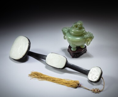 View full screen - View 1 of Lot 6. A wood silver-inlaid and white jade inset ruyi sceptre and a celadon jade 'lion' incense burner and cover, Republican period | 民國 木錯銀嵌白玉如意 及 清白玉瑞獸鈕雙龍活環耳瓜棱式三足蓋爐 一組兩件.