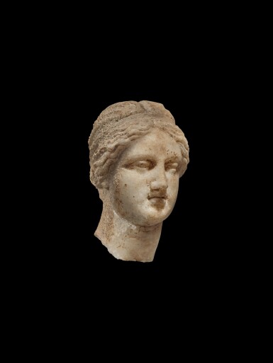 View full screen - View 1 of Lot 106. A Marble Head of a Woman, perhaps a Goddess, Hellenistic or early Roman, circa 2nd century B.C..