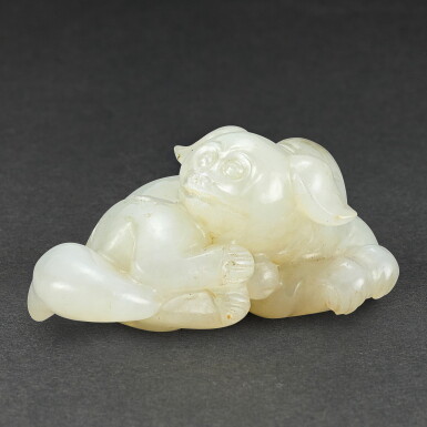 View full screen - View 1 of Lot 566. A WHITE AND BROWN JADE FIGURE OF A DOG LATE QING DYNASTY - REPUBLICAN PERIOD | 清末至民國 白玉臥犬.