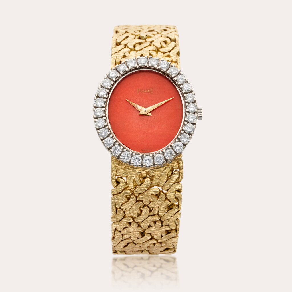 View full screen - View 1 of Lot 464. Reference 9814 N66 | A white and yellow gold and diamond-set oval bracelet watch with coral dial, Circa 1970.