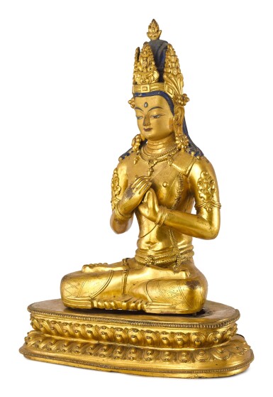 A LARGE GILT-BRONZE FIGURE OF VAIROCANA, TIBET, THE FIGURE CIRCA 1900, THE STAND CIRCA 1400 | 約1900年 藏傳鎏金銅毗盧遮那佛坐像 配 約1400年 鎏金銅蓮座