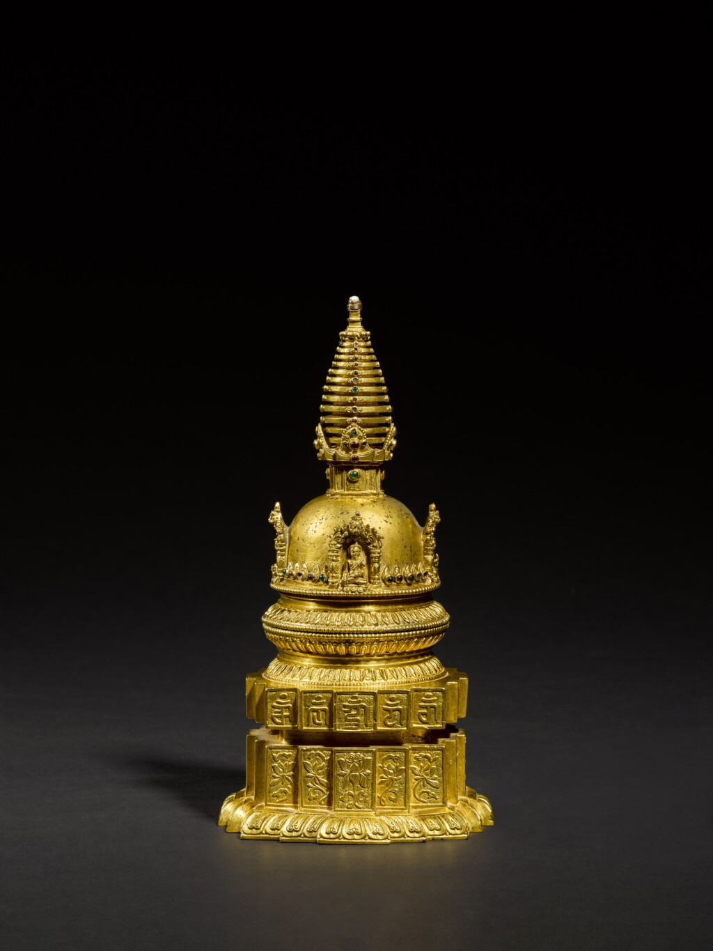 View full screen - View 1 of Lot 179. A magnificent and very rare Imperial gilt-copper stupa and gilt-copper alloy throne, The stupa Nepal, 15th century, The throne four-character mark and period of Qianlong | 尼泊爾 十五世紀 鎏金銅合金嵌寳石佛塔 配 清乾隆 鎏金銅座.