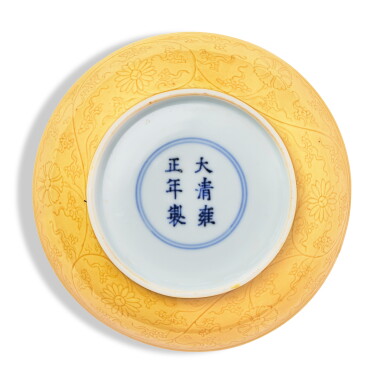 View full screen - View 1 of Lot 512. An incised yellow-glazed 'floral' dish, Mark and period of Yongzheng | 清雍正 黃釉暗刻纏枝花卉紋盤 《大清雍正年製》款.