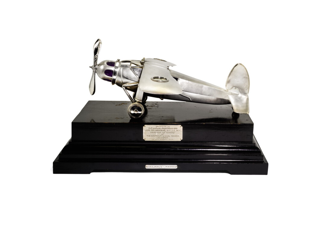 View full screen - View 1 of Lot 144. An Indian silver presentation document case in the form of an aeroplane, Surajmal Lullubhai & co, Madras, circa 1934.