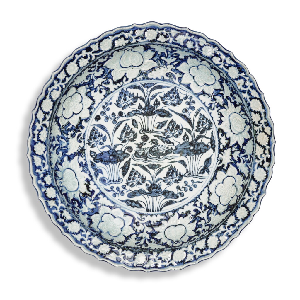 View full screen - View 1 of Lot 8. A rare large blue and white moulded 'mandarin duck and lotus pond' dish, Yuan dynasty | 元 青花荷塘鴛鴦紋花口大盤.