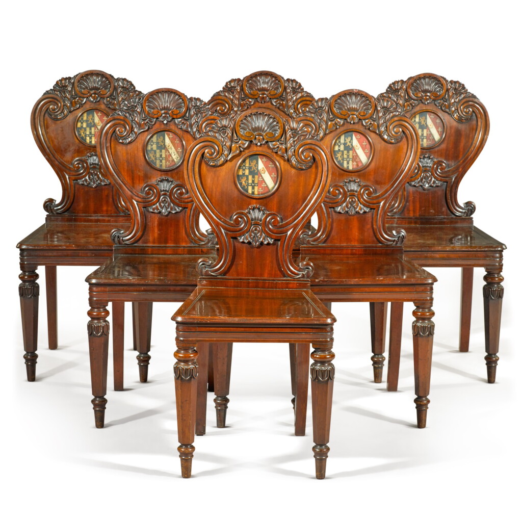 View full screen - View 1 of Lot 71. A set of six George IV carved mahogany hall chairs, circa 1822, in the manner of Gillows.