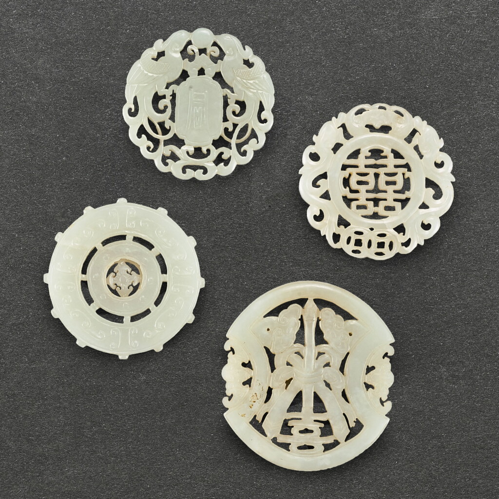 View full screen - View 1 of Lot 582. FOUR WHITE JADE RETICULATED PLAQUES QING DYNASTY | 清 白玉圓形珮飾一組四件.
