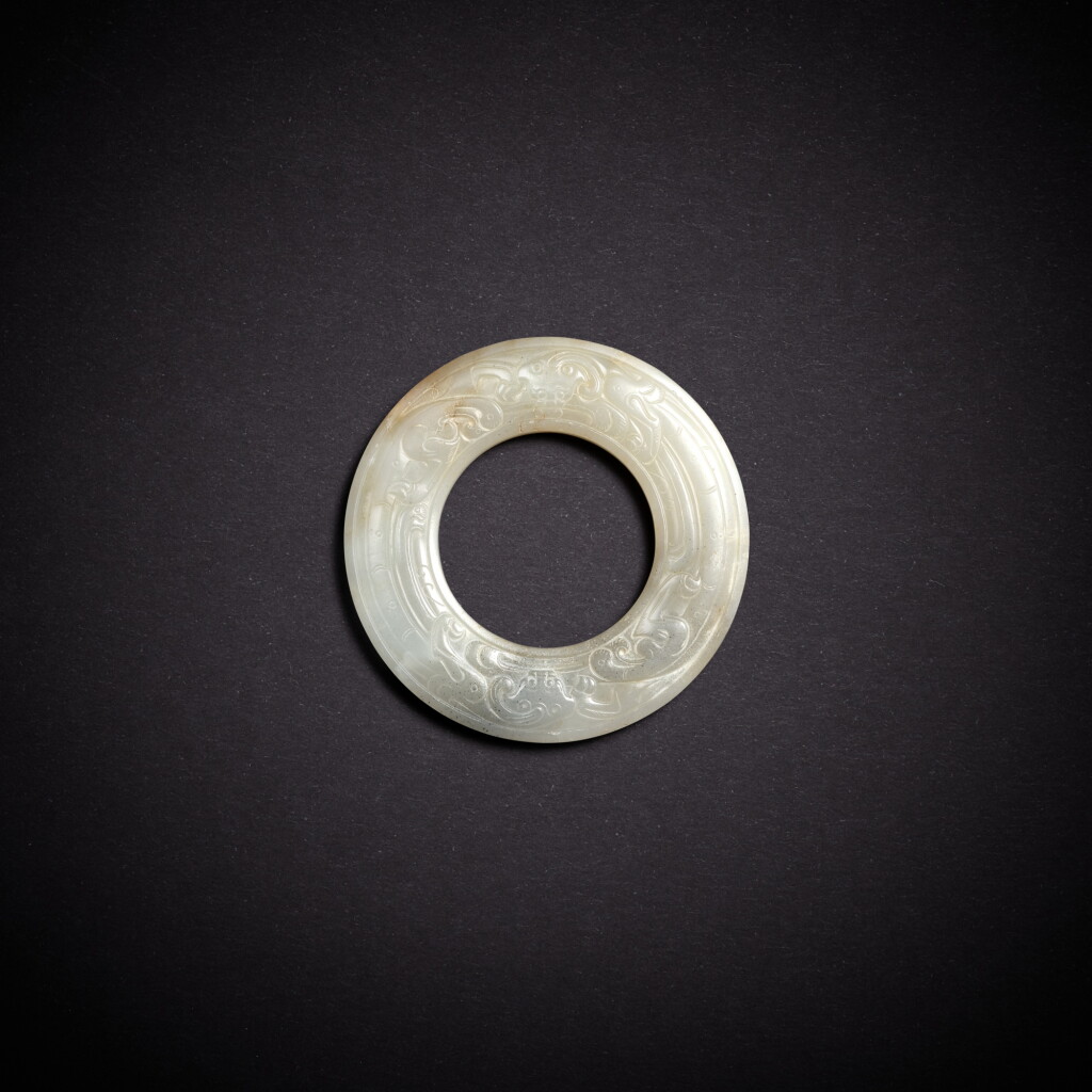 View full screen - View 1 of Lot 5665. A white jade 'chilong' disc, huan, Southern Song dynasty | 南宋 白玉螭龍紋環.