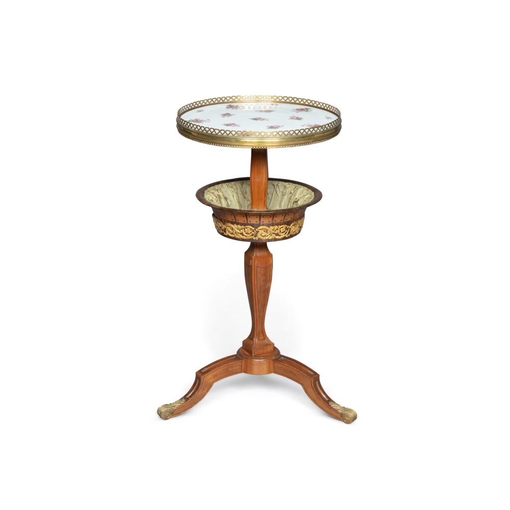View full screen - View 1 of Lot 59. A Louis XVI style gilt-bronze and porcelain mounted bois satiné tricoteuse | Tricoteuse en bois satiné avec porcelaine et bronze doré, de style Louis XVI .