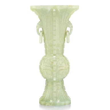 View full screen - View 1 of Lot 27. An archaistic celadon jade gu-form vase, 20th century | 二十世紀 青玉雕仿古饕餮紋獸耳活環出戟海棠式花觚.
