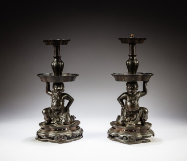 View full screen - View 1 of Lot 222. A pair of bronze 'foreigner' candlesticks, Ming dynasty, 17th century | 明十七世紀 銅胡人燭臺一對.
