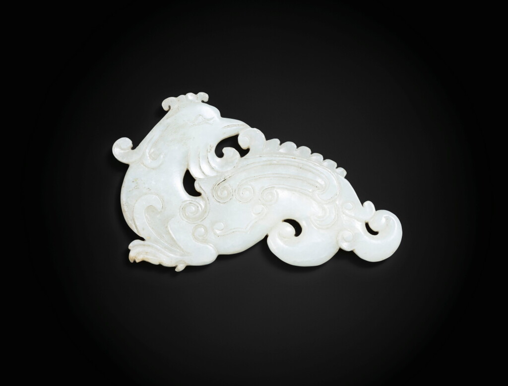 View full screen - View 1 of Lot 100. A white jade archaistic 'phoenix' plaque Qing dynasty, 18th-19th century | 清十八至十九世紀 白玉雕鳳凰珮.