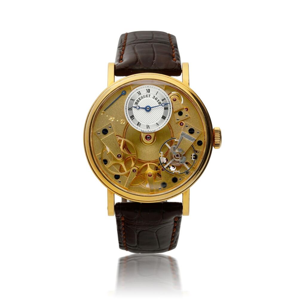 View full screen - View 1 of Lot 154. BREGUET | REFERENCE 7027 LA TRADITION A YELLOW GOLD SEMI-SKELETONIZED WRISTWATCH WITH POWER RESERVE INDICATION, CIRCA 2006.