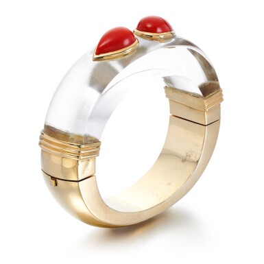 View full screen - View 1 of Lot 24. Coral and rock crystal bangle, 1970s.