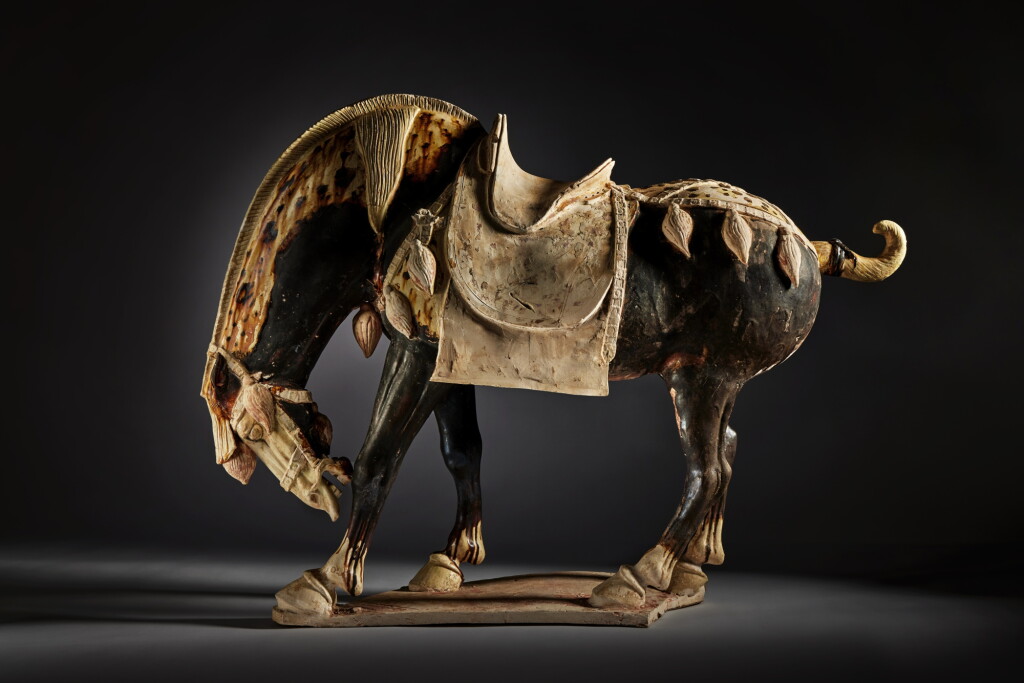 View full screen - View 1 of Lot 161. A magnificent and extremely rare gilt-decorated and sancai-glazed pottery figure of a bowing horse, Tang dynasty, first half of 8th century.