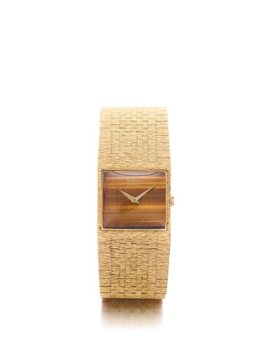 View full screen - View 1 of Lot 167. CHOPARD | A YELLOW GOLD BRACELET WATCH WITH TIGER'S EYE DIAL CIRCA 1980.