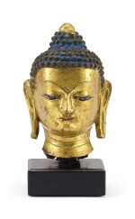 A GILT-BRONZE HEAD OF SHAKYAMUNI BUDDHA, TIBET, 15TH CENTURY | 十五世紀 藏傳鎏金銅釋迦牟尼佛首