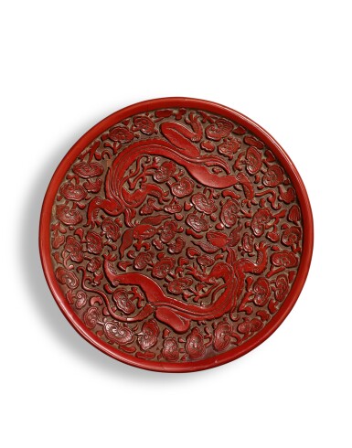 View full screen - View 1 of Lot 9882. A rare carved cinnabar lacquer 'chilong' dish, Song - Yuan dynasty | 宋至元 剔紅雙螭穿靈芝紋盤.