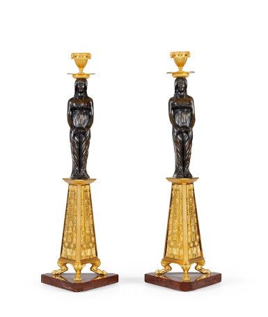 View full screen - View 1 of Lot 45. A pair of Directoire patinated and gilt-bronze candlesticks, circa 1800 | Paire de bougeoirs en bronze doré et patiné d'époque Directoire, vers 1800.