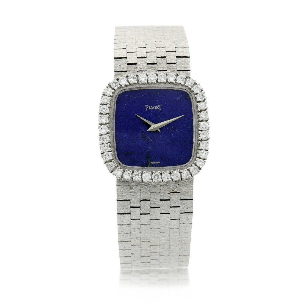 View full screen - View 1 of Lot 111. A white gold and diamond-set cushion shaped bracelet watch with lapis lazuli dial, Circa 1970.