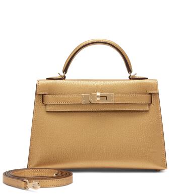 View full screen - View 1 of Lot 5. Limited Edition Dore Chèvre Chamkilight Metallic Mini Kelly II 20 Permabrass Hardware, 2024.