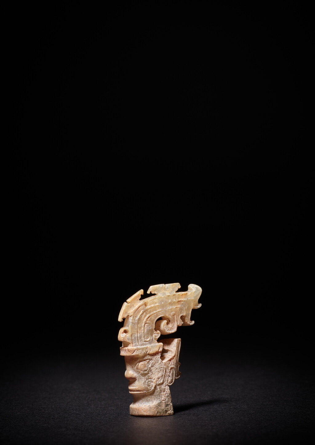 View full screen - View 1 of Lot 3607. An exceptionally rare jade 'mask' ornament, Shang dynasty or earlier | 商或較早 卷尾形高冠神人首玉飾.