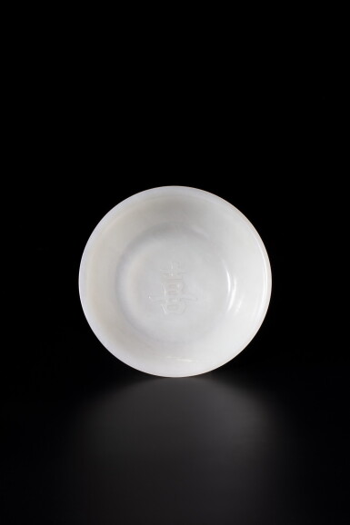 View full screen - View 1 of Lot 7. A rare white jade 'happiness' dish Qing dynasty, Qianlong period | 清乾隆 白玉雕「喜」字紋盤 《未》款 .