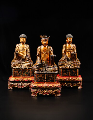 View full screen - View 1 of Lot 185. A set of three gilt-lacquer wood figures of Buddha, Qing dynasty, 19th century | 清十九世紀 漆金木雕佛坐像 一組三件.